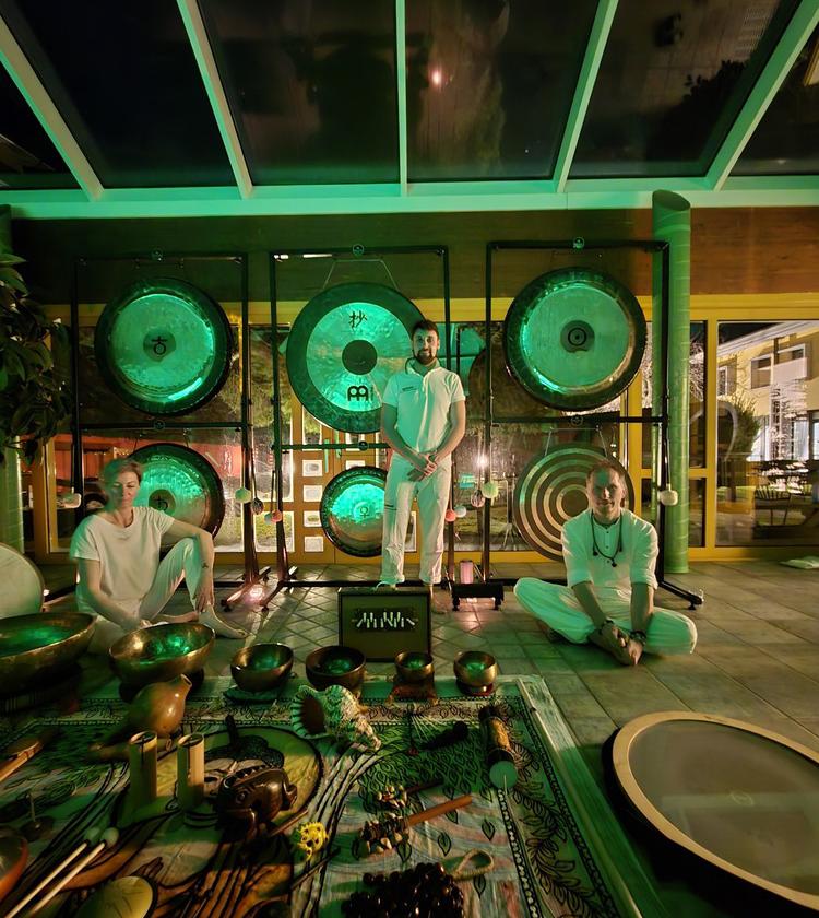 Tre persone, strumenti etnici e gongs, atmosfera verde, vibrazioni mistiche e rilassanti.
